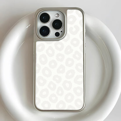 Silver and white leopard pattern smartphone case, close-up rear camera angle