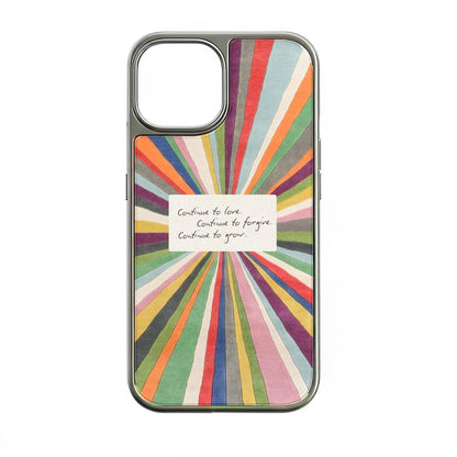 Colorful sunburst illustration with an inspirational handwritten note in the center reading: "Continue to love. Continue to forgive. Continue to grow."