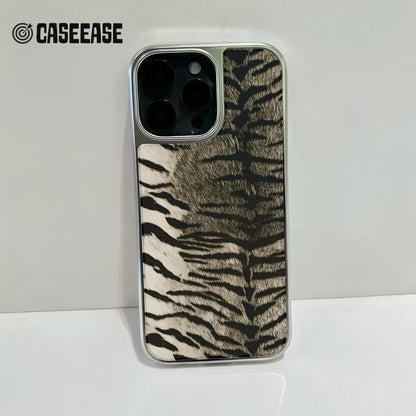 Silver phone case with black and beige zebra pattern, rear camera close-up